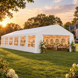 Large white party tent set up for a wedding reception on a lawn