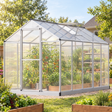 Polycarbonate greenhouse with plants in a backyard vegetable garden