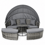 Wicker patio daybed sofa set with retractable canopy on white background