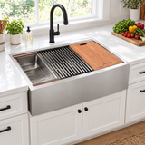 Farmhouse workstation sink installed in a modern white kitchen