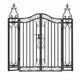 Black ornamental wrought iron garden gate on white background